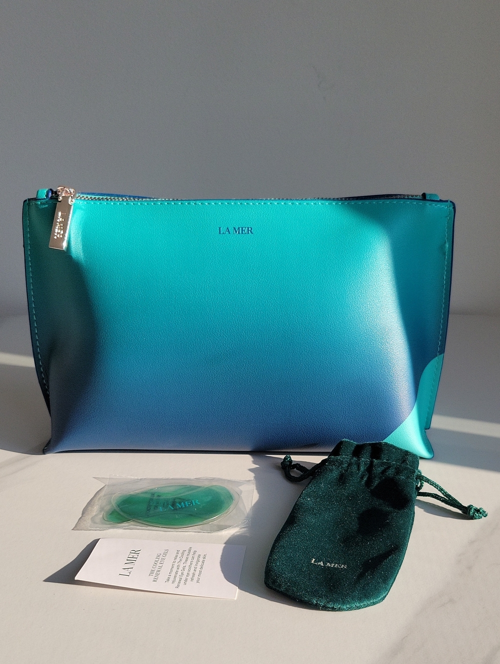 La Mer Gradient Teal & Blue Large Cosmetic Pouch And The Cooling Eye Gels